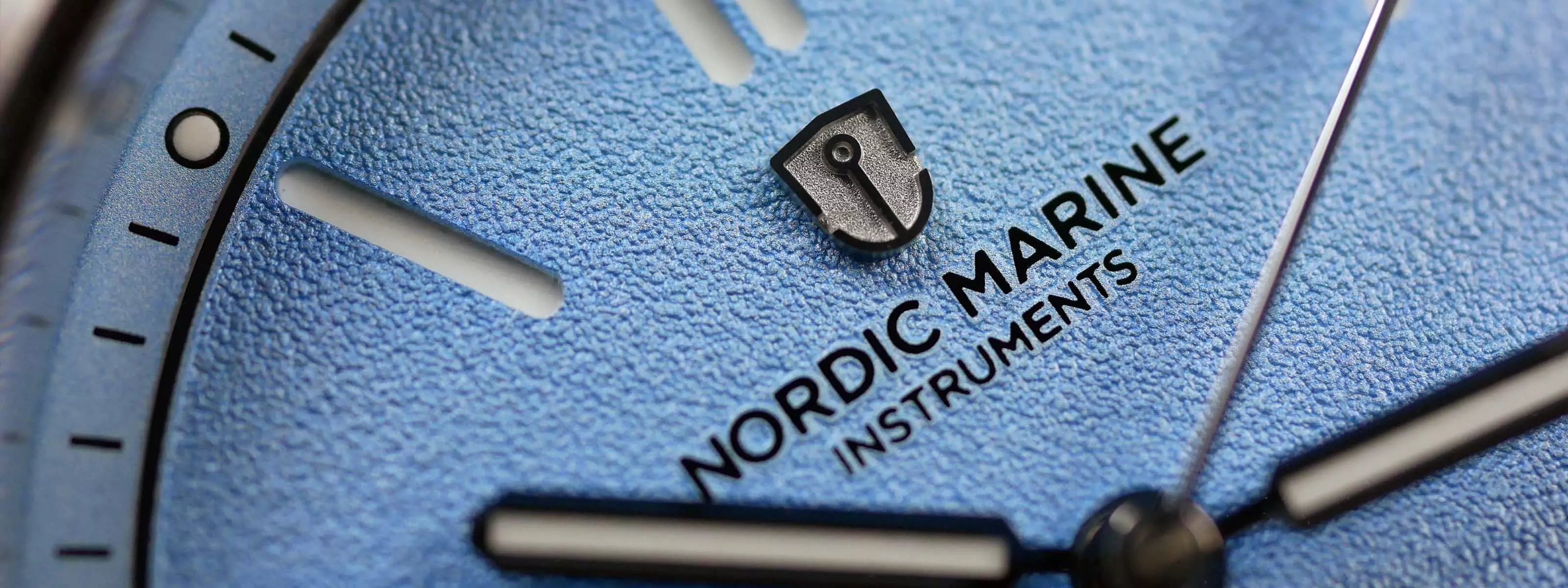 Close-up Nordic Marine Instruments watch with a frosted structured blue dial